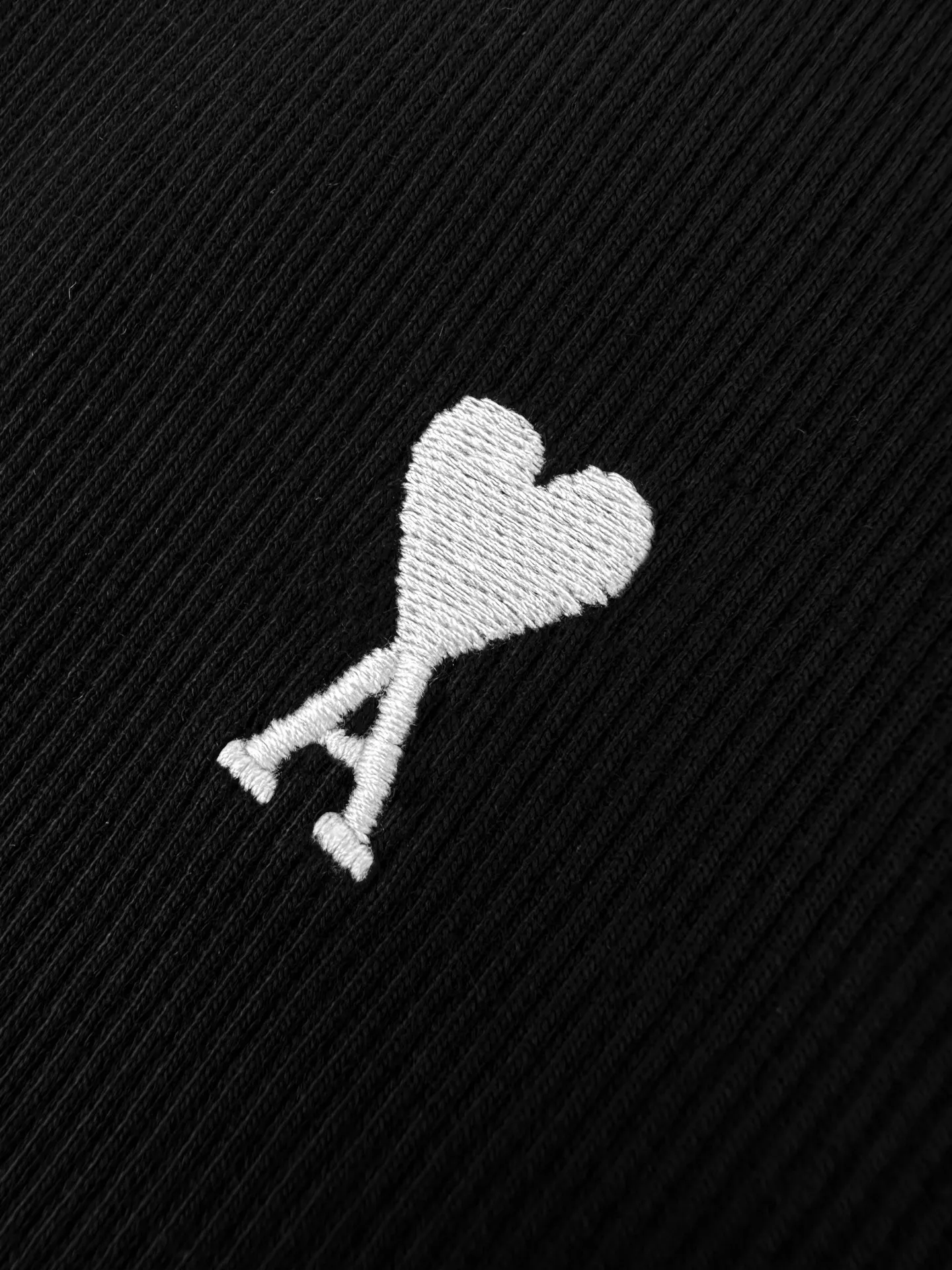 Logo embroidered vest Customized luxurious and soft plain cotton, cloudy and skin-friendly, clean and refreshing Breathable, simple black tones embody French sophistication, showing a luxurious style when relaxed. Love logo lightly embroidered on the front, Ami embroidery on the back neck with dark engraved texture, French attitude on both sides, minimalist and quality, interior with hidden charm, easy to wear alone, Versatile is elegant and effortless. Process 1: Using imported machine embroidery technology Use advanced computer control systems and precision mechanical components to achieve Ami logo and letter embroidery operations with high precision and smooth and delicate lines. Process 2: The fabrics have been fermented and washed for a better hand feel. Not easy to deform, not easy to shrink, not easy to fade, and maintain long-term beauty. Accessories: Customized 1:1 Ami trademark. Version: Fitted version. Size: S M L XL. Style number: AA 603.